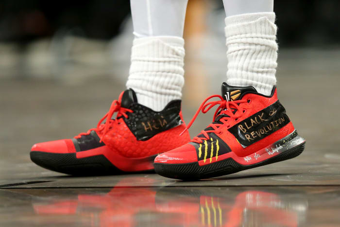 View of red and black Nike Kyrie shoes.